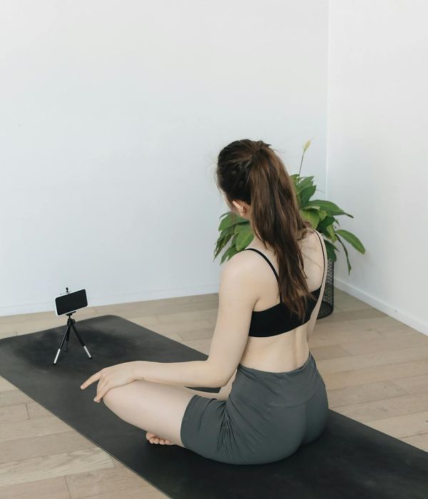 Person doing a fluid yoga transition in a minimalist setting.