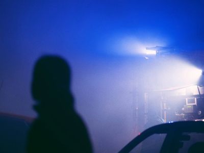 Silhouette of a person in meditation against a dark background.